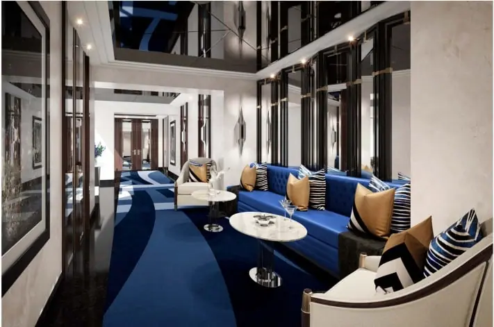 Restaurant lounge with deep blue sofas, cushions and round marble tables