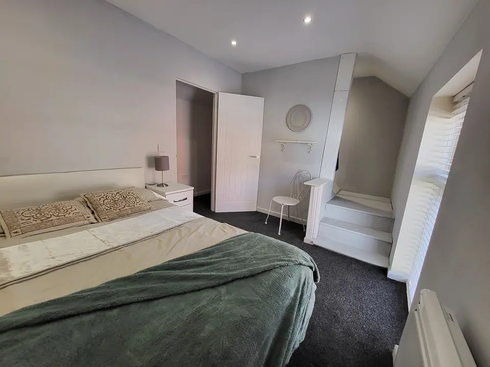 Bedroom with stairs and a skylight in the converted property
