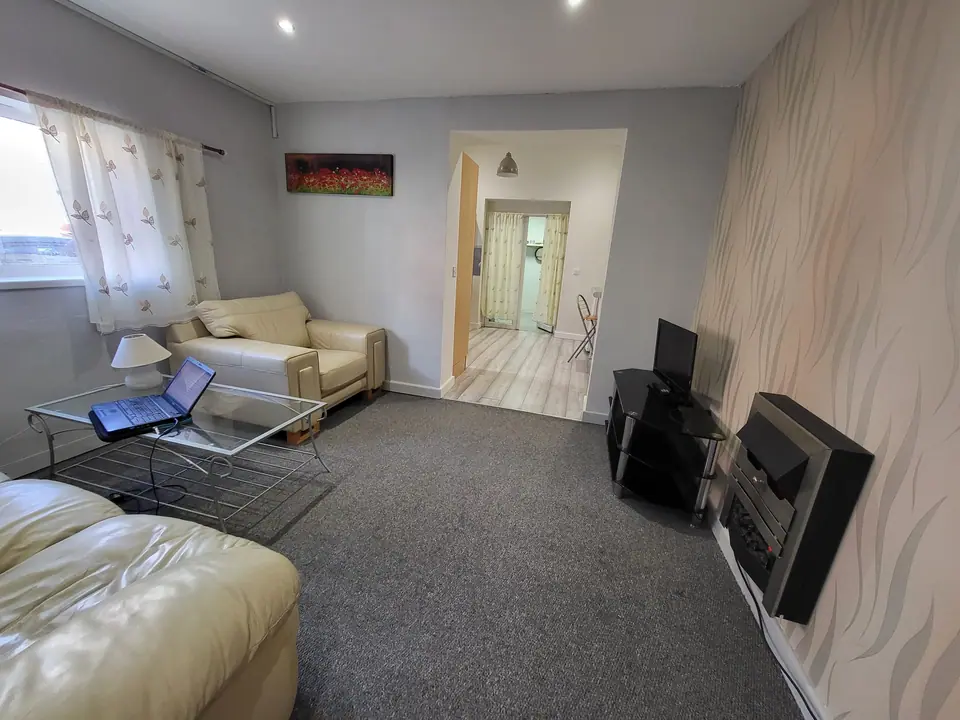 Living room in the converted property with cream sofa