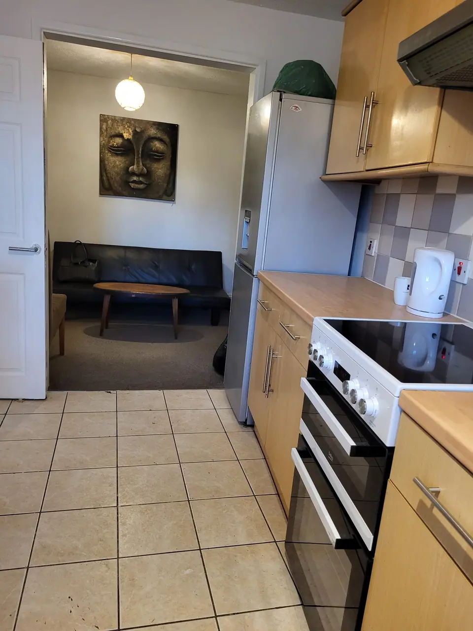 Galley kitchen with view through to the living room