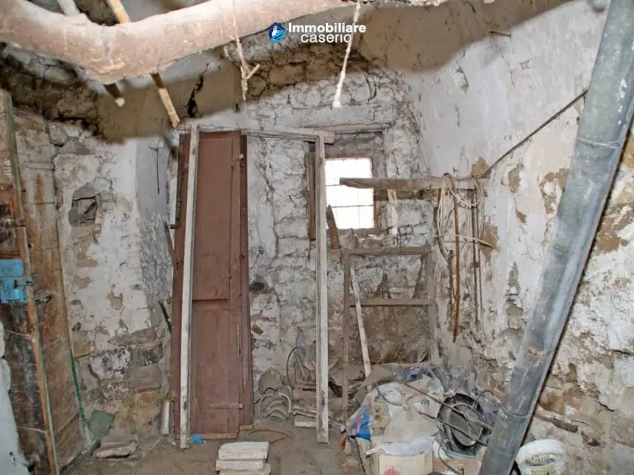 Cellar during strip-out with props and debris